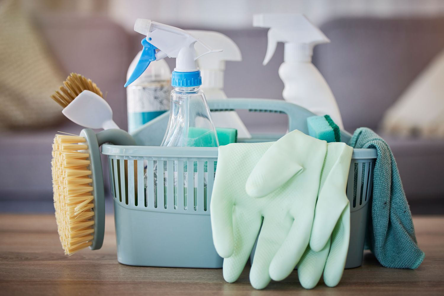 Bright basket of ClearShine cleaning supplies on a wooden floor